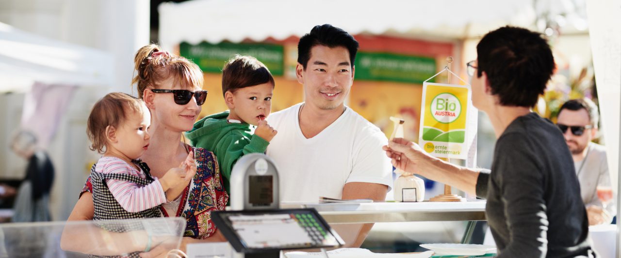 Personen kaufen bei einem Marktstand am Bio-Fest ein