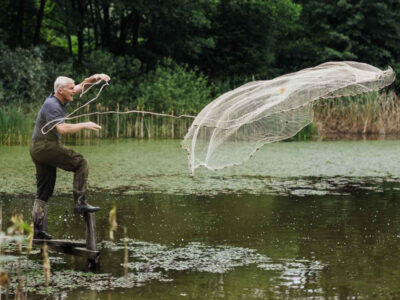 Mann wirft Fischnetz