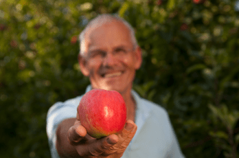 Biobauer Loidl mit rotem Apfel in der Hand